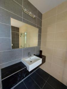 a bathroom with a white sink and a mirror at ●STG12●3-Storey●Private House●2step Access Garden● in Bayan Lepas