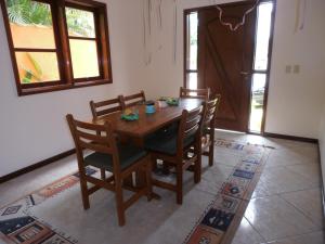 a wooden dining room table and chairs in a room at Casa Riviera de São Lourenço in Riviera de São Lourenço