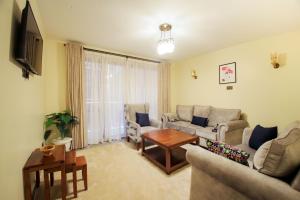un salon avec un canapé et une table dans l'établissement Lantern Serviced Apartments, à Nairobi