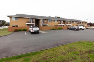 a parking lot in front of a building at RIVERWALK SEASIDE- Walk to beach, One level home, pet friendly in Seaside