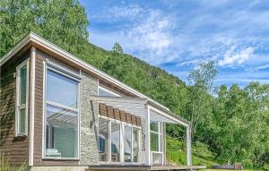 a house with large windows in front of a mountain at Nice Home In Ornes With House Sea View in Ornes