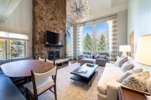 a living room with a couch and a table at Lodge at Vail Condominiums in Vail