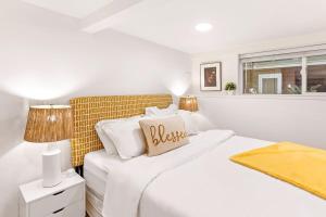 a white bedroom with a bed and a window at NEW: Bright, Peaceful Retreat in Iconic Seattle Neighborhood in Seattle