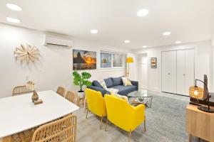 a living room with a couch and a table and chairs at NEW: Bright, Peaceful Retreat in Iconic Seattle Neighborhood in Seattle