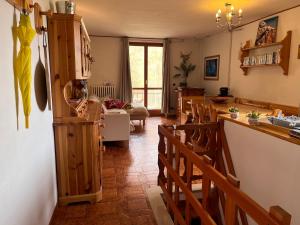 a kitchen and living room with chairs and a counter at La Baita Limone Riserva Bianca Ski-in Ski-out Seggiovia Morel 2 in Limone Piemonte