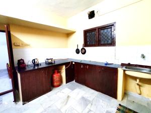 a kitchen with a sink and a counter top at Beach/US Russian Consulate/Kitchen/Unlimited Super Fast Wifi in Chennai
