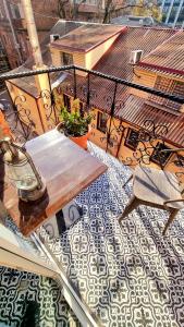 a patio with a table and chairs on a balcony at Old Town #Menorah #MostCity in Dnipro +66 photos