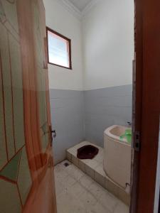 a bathroom with a tub and a toilet in it at Puri Merbabu Asri 