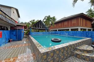 a swimming pool with a blue fence around it at Capital O 90664 Rabi Hotel in Kota Bharu