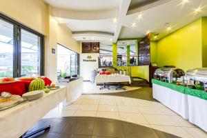 a restaurant with yellow and green walls and a cafeteria at Hotel Rio in Nairobi