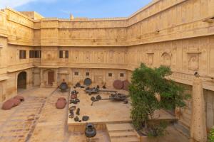 a large building with a group of people in the courtyard at WelcomHeritage Mandir Palace in Jaisalmer