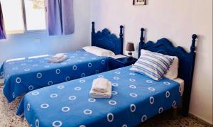 A bed or beds in a room at Pensión Playa