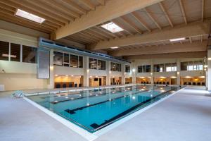 a large swimming pool in a large building at Fiald Hotel & Spa in Bacău