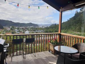 a balcony with chairs and a table and a view at Garden View Cottages in Picton