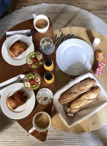 a table with plates of bread and cups of coffee at La Suite Gignac in Gignac