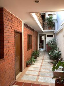a brick hallway with potted plants in a building at San Gil beautiful house in San Gil