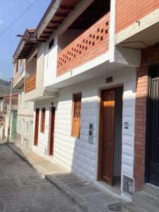 a white building with a door on a street at San Gil beautiful house in San Gil +16 photos