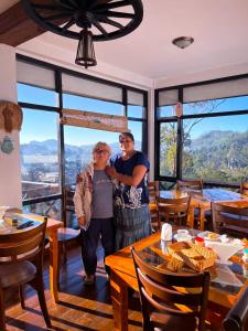 a man and a woman standing in a restaurant at Chez Allen in Nuwara Eliya