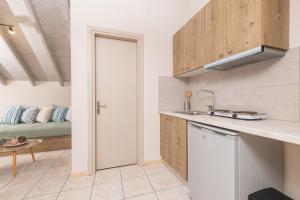 une cuisine avec un évier et un canapé dans une chambre dans l'établissement Koukos Loft Apartments, à Tsilivi