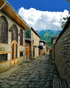 a cobblestone street in a village with a building at İsmayilov's-Lahij hotel in İsmayıllı