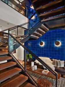 a staircase in a room with a blue tiled wall at Arlo SoHo in New York