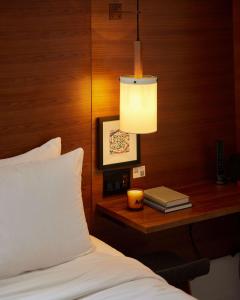 a bedroom with a bed and a desk with a lamp at Arlo SoHo in New York