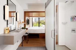 a bathroom with a sink and a bed in a room at Arlo SoHo in New York