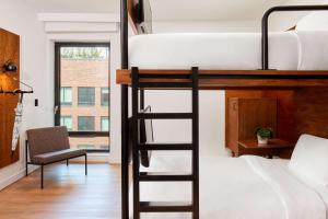 a bedroom with a bunk bed and a chair at Arlo SoHo in New York