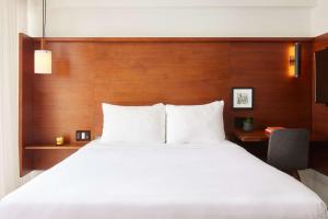 a hotel room with a bed and a lamp at Arlo NoMad in New York
