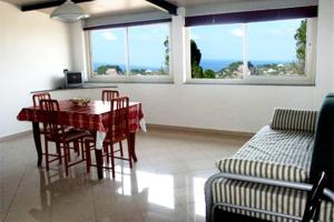 a living room with a table and chairs and a couch at Appartamenti Pirrera in Patti