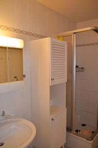 a white bathroom with a sink and a shower at Miramar-App-08 in Ahlbeck