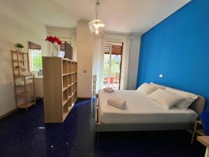 a bedroom with a bed and a blue wall at APPARTME Guest House Seveso 40 in Milan
