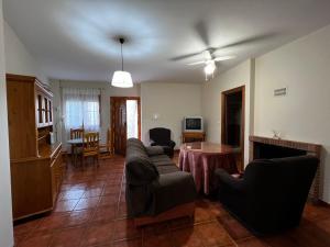 a living room with a couch and a table at Casa Rural Cerezo in Torviscón
