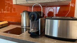 a kitchen counter with a toaster and a coffee maker at Stilvolle Wohnung in idyllischer Lage in Bad Säckingen