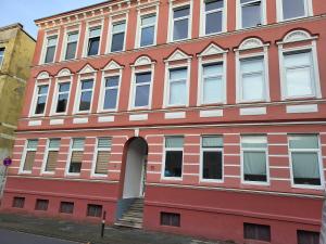 a large red building with an open door at Frisch renoviert – ruhig aber dennoch sehr zentral gelegen in Wilhelmshaven