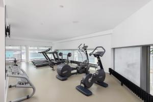 a gym with several treadmills and cardio machines at VISIONAPARTMENTS Basel Nauenstrasse - contactless check-in in Basel