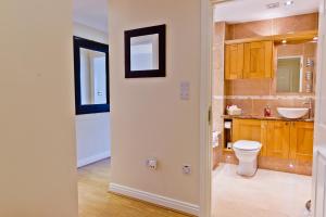 a bathroom with a toilet and a sink at Watermark Apartments in Whitby