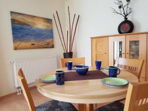 a dining room table with blue dishes on it at Strandoase-Whg-14 in Heringsdorf