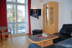 a living room with a couch and a table at Seeschloss-App-05 in Heringsdorf