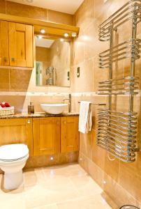 a bathroom with a toilet and a sink at Watermark Apartments in Whitby