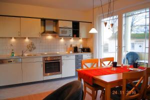 a kitchen with a table and a dining room at Strandoase-Whg-16 in Heringsdorf