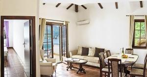 a living room with a couch and a table at Apartments Boka Vista in Kamenari