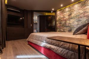 a bedroom with a large bed and a tv at Luxury apartment in the superb location in Chişinău