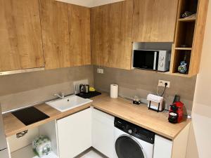 a kitchen with a sink and a washing machine at DISTRiCT 01 - Kalamaria in Thessaloniki