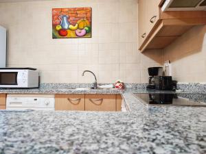 a kitchen with a counter top and a microwave at AC Apartaments Pleta Soldeu in Soldeu