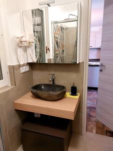 a bathroom with a sink and a mirror at Casa ORI in Perledo