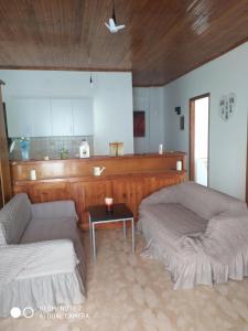 uma sala de estar com duas camas e uma mesa em XRYSA PAP em Tolofón