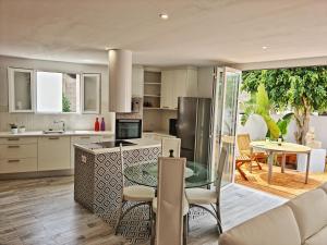 a kitchen with a glass table and a dining room at FINCA BEROLO 1 in Guía de Isora