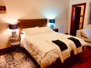 a bedroom with a large bed and a couch at Elizabeth's Cottage in Montagu