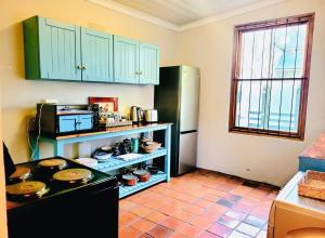 a kitchen with a stove and a refrigerator at Elizabeth's Cottage in Montagu